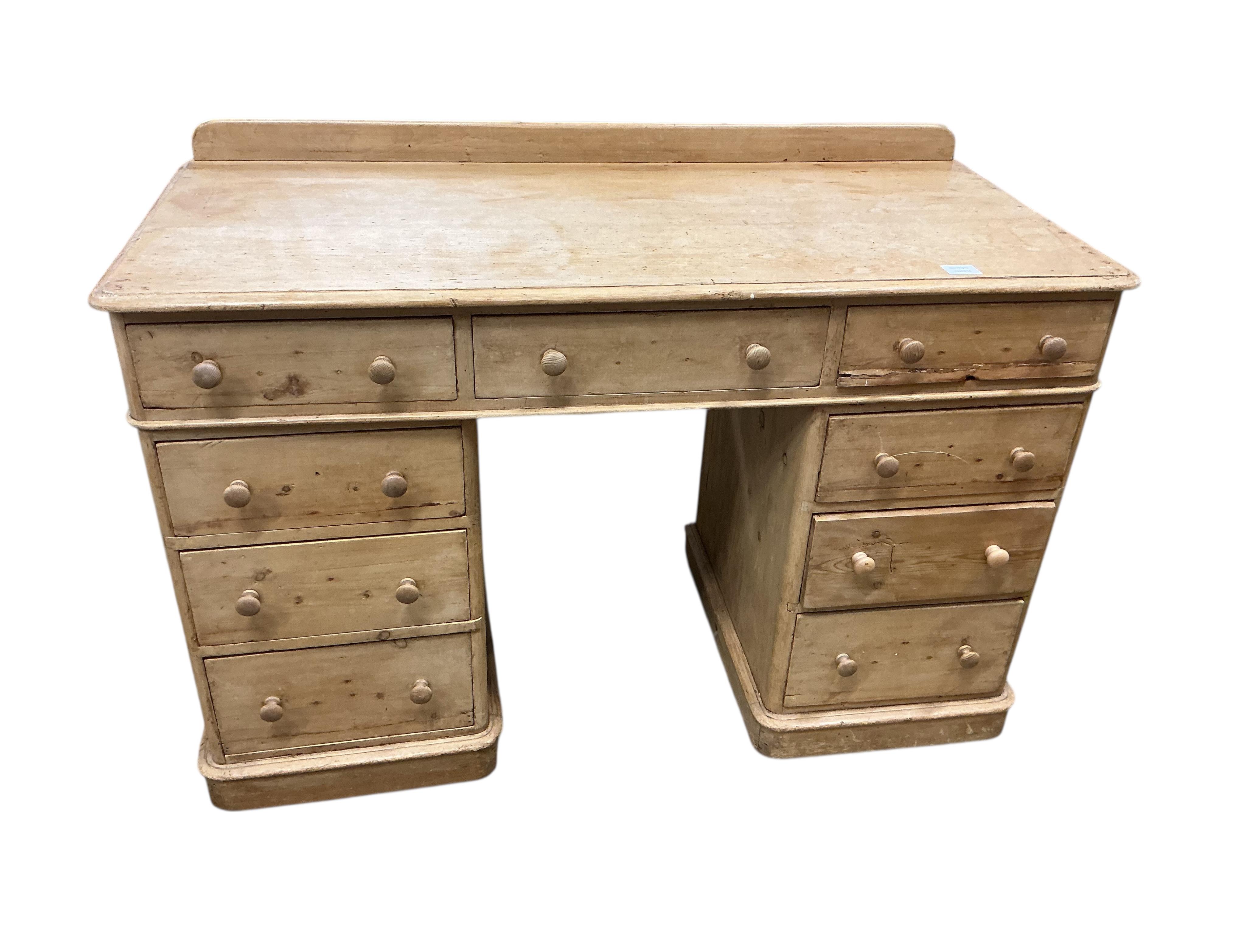 A Victorian pine pedestal desk, fitted with nine small drawers, width 122cm, depth 54cm, height 82cm